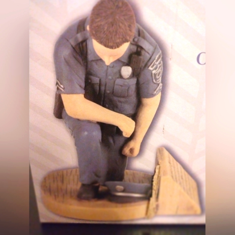 SPACE THAT SPEAKS: NWT DIckson's Police Officer's Prayer, kneeling in uniform